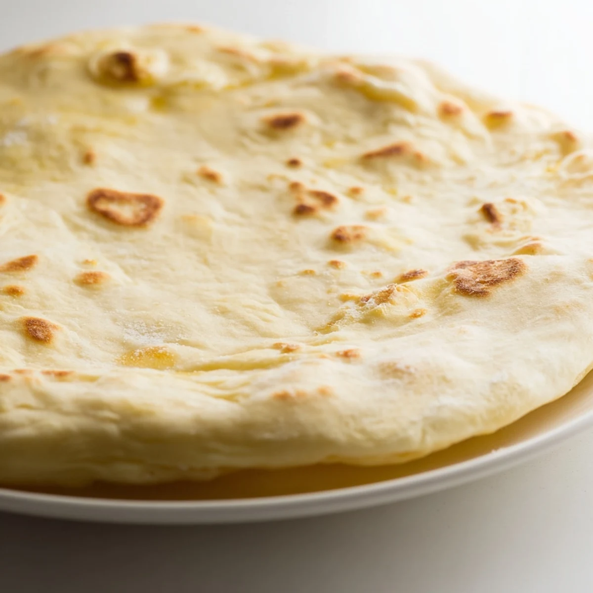 Golden-brown Three-Ingredient Flatbreads, ready to be torn and dipped into creamy hummus, delicious!