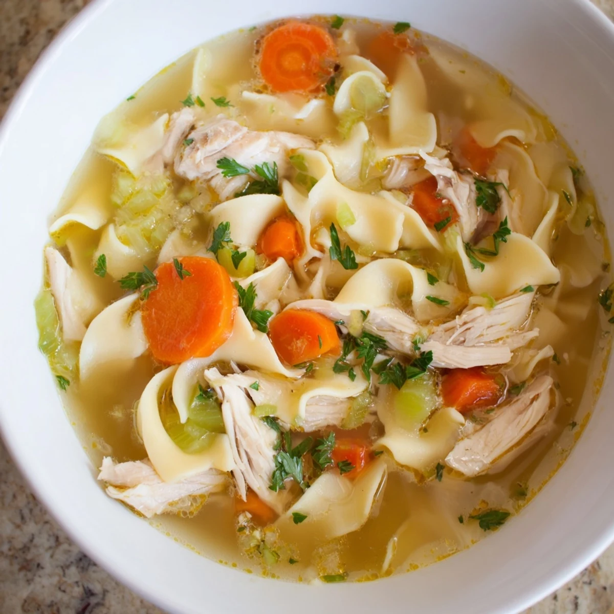 Steaming bowl of golden Cozy Chicken Noodle Soup from Scratch, ready to warm you on a chilly day.