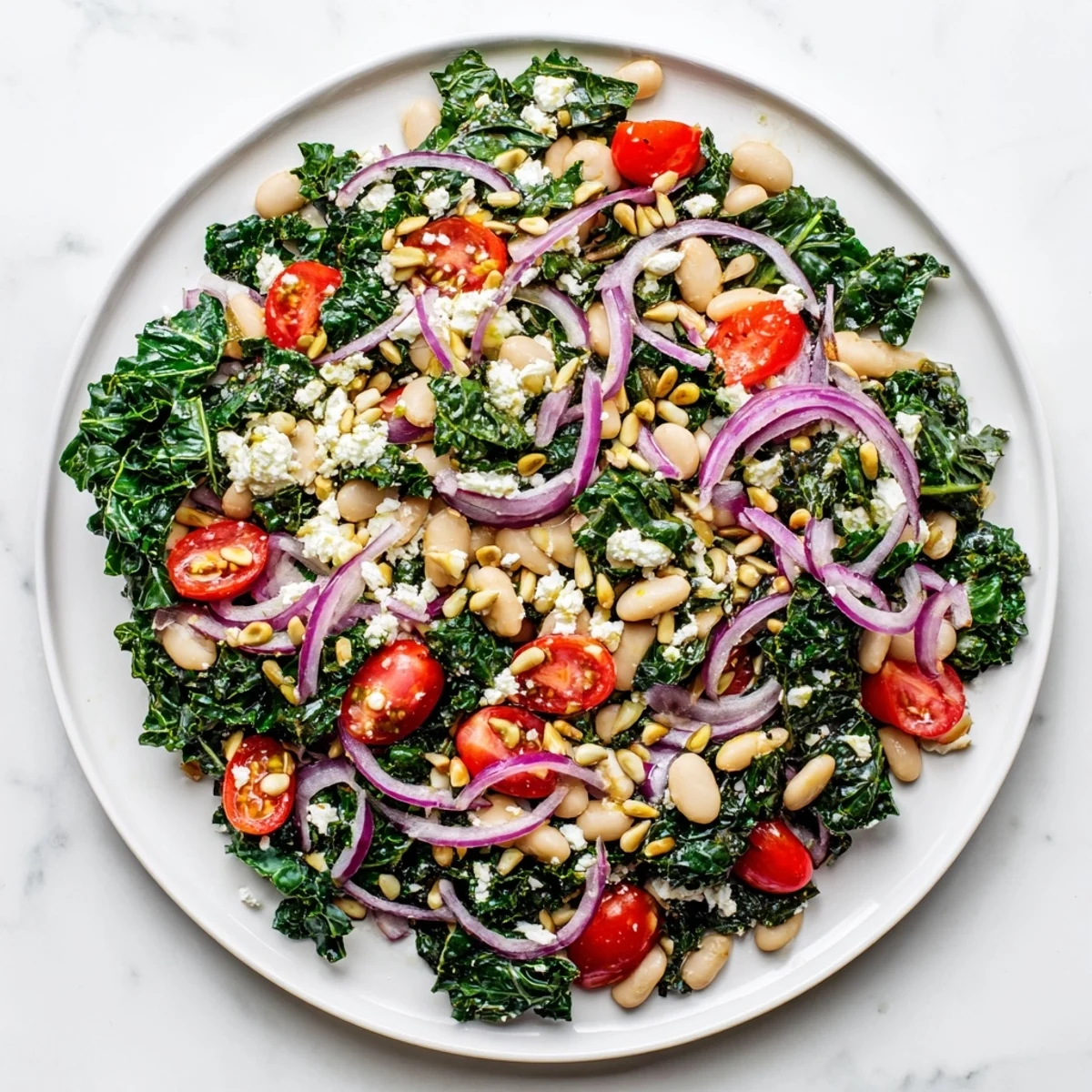 Creamy white beans and massaged kale shine in this hearty White Bean and Kale Salad, tossed with a bright lemon-garlic dressing and cherry tomatoes for a fresh, satisfying bite. 