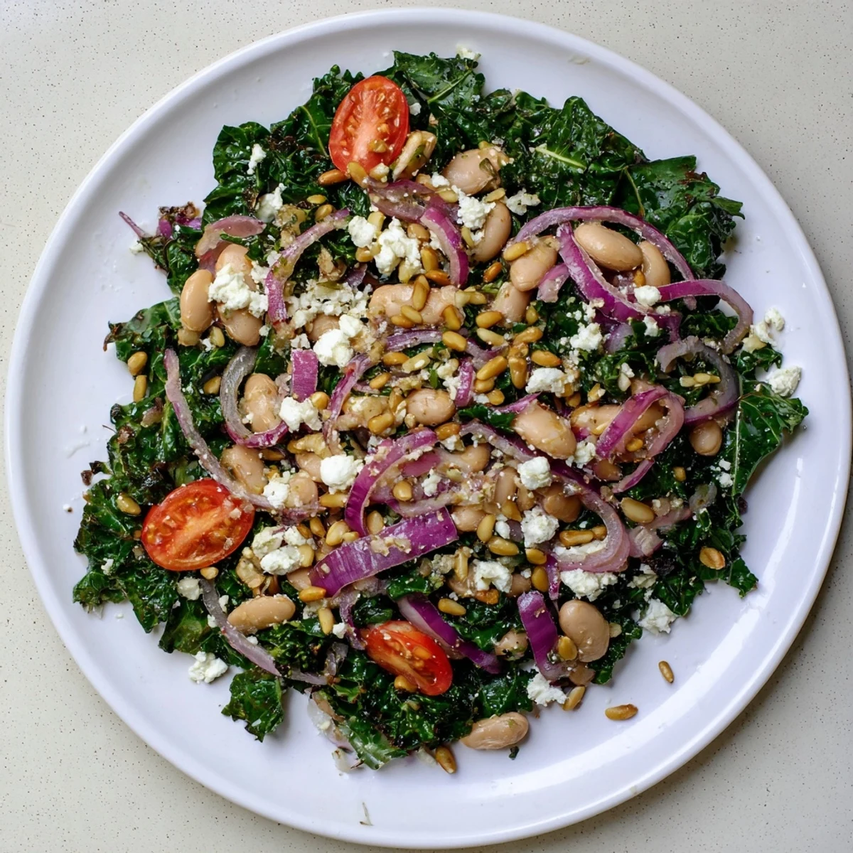 Enjoy this easy White Bean and Kale Salad featuring protein-rich cannellini beans, tender greens, and a zesty lemon vinaigrette, served with optional toasted sunflower seeds for crunch.