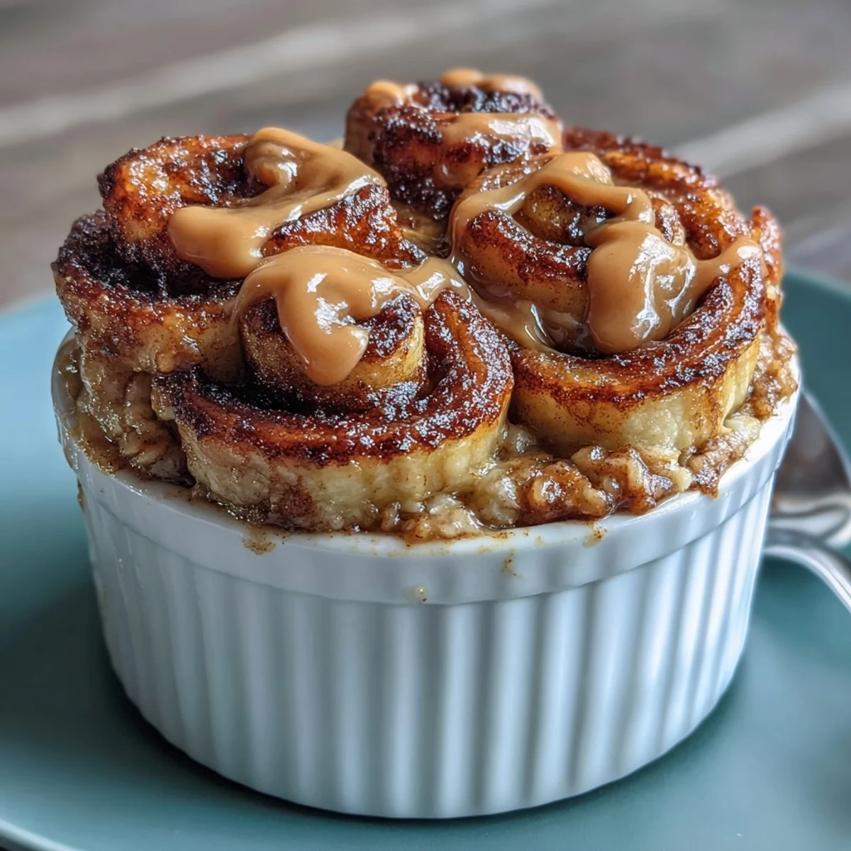 Freshly baked Cinnamon Swirl Protein Banana Baked Oats with banana slices, creamy yogurt, and drizzle of nut butter