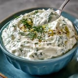 Plated Greek Skyr Tzatziki with vibrant cucumber and olive oil drizzle.