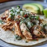 Juicy shredded chicken in vibrant salsa verde, ready for easy weeknight tacos.