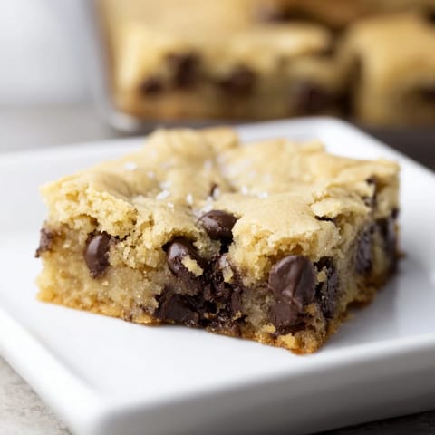 Freshly baked Ultimate Gooey Chocolate Chip Cookie Bars with melted chocolate, perfect dessert squares.