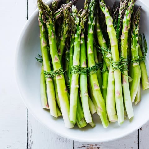 Fresh-made Botanical Lattice: a close-up of colorful berries nestled within asparagus weave.
