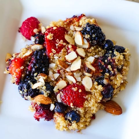 A close-up view of a vibrant Berry Quinoa Breakfast Bake, showing the quinoa and berry layers.