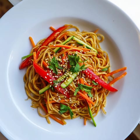 Freshly made Garlic Noodle Salad ready to eat, featuring bright carrots and a savory dressing.