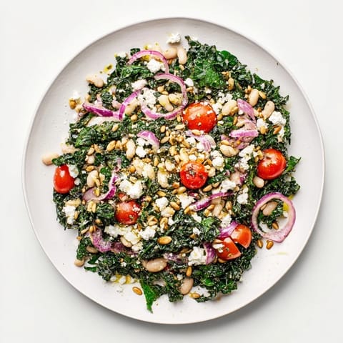 A close-up of the vibrant White Bean and Kale Salad shows glistening olive oil dressing, crisp kale leaves, and creamy beans, perfect for a light lunch or healthy dinner side. 