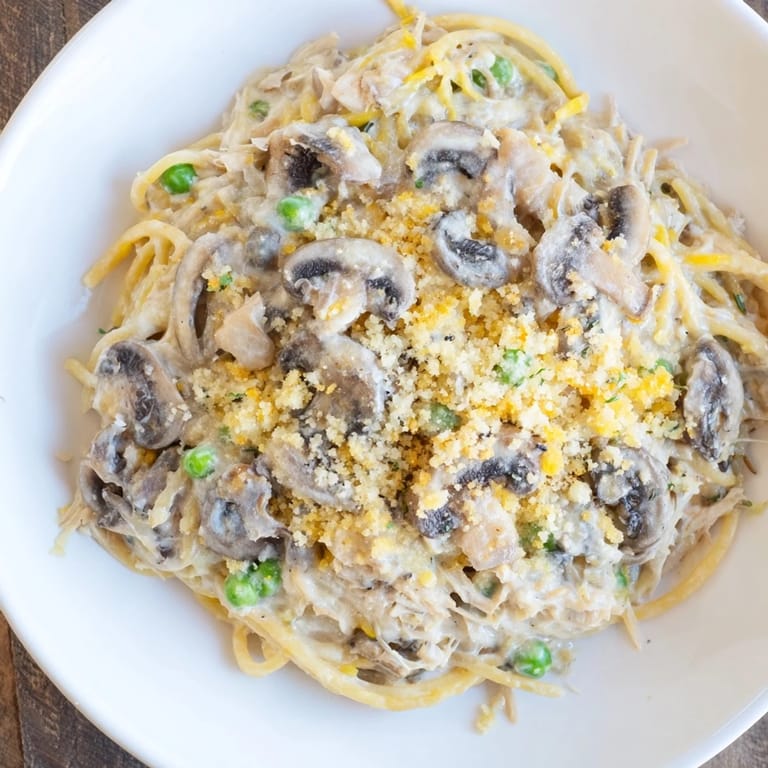Enjoy a steaming plate of Turkey Tetrazzini, a classic American casserole brimming with savory flavors and textures.