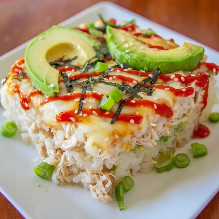 A delicious baked Chicken Sushi Bake with melted cheese, flavorful chicken, and a sprinkle of furikake seasoning.