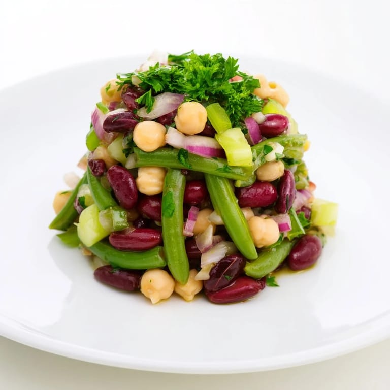 Freshly prepared Three-Bean Salad in a light vinaigrette, ready to serve chilled as a colorful and healthy side dish.