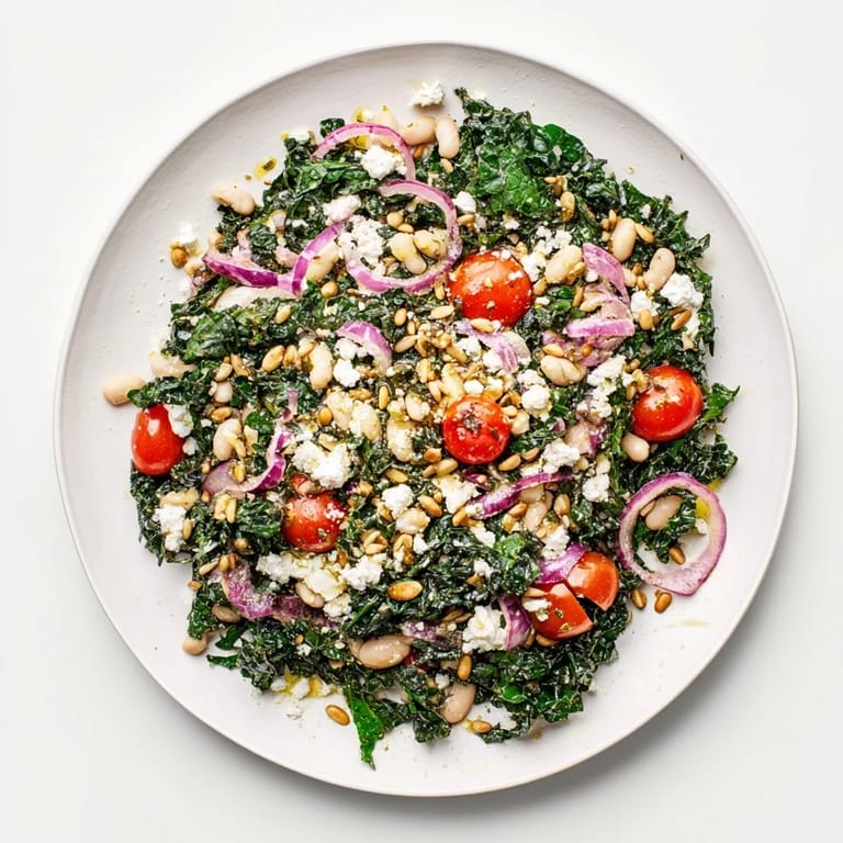 A close-up of the vibrant White Bean and Kale Salad shows glistening olive oil dressing, crisp kale leaves, and creamy beans, perfect for a light lunch or healthy dinner side. 