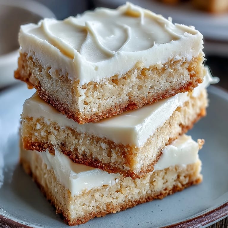 Golden-baked almond flour sugar cookie bars topped with smooth vanilla frosting, a delicious gluten-free treat for any occasion.