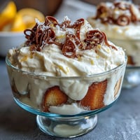Zesty limoncello tiramisu cups with creamy mascarpone and lemon zest garnish