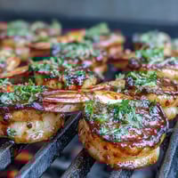 Golden seared scallops bathed in a zesty lemon butter sauce, garnished with fresh parsley for an elegant spring meal.